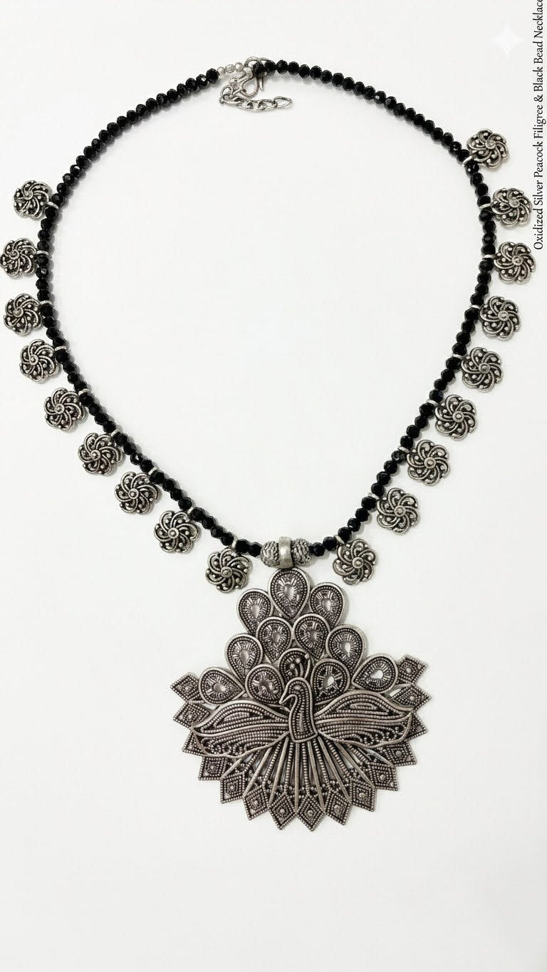 Peacock silver brooch and black beaded necklace